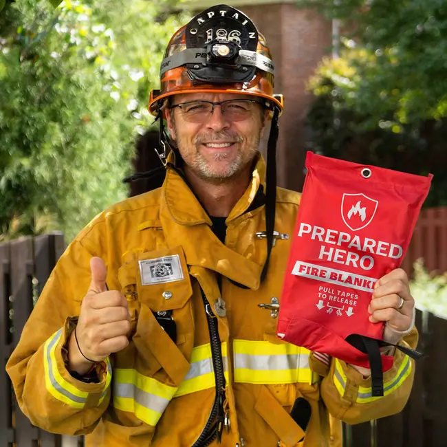 Fire captain holding the Prepared Hero Fire Blanket